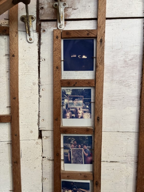 Three polaroid photos affixed to a wall.
