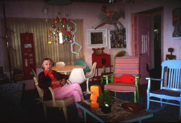 Mary Nohl sits on a chair in her home, surrounded by things she created.